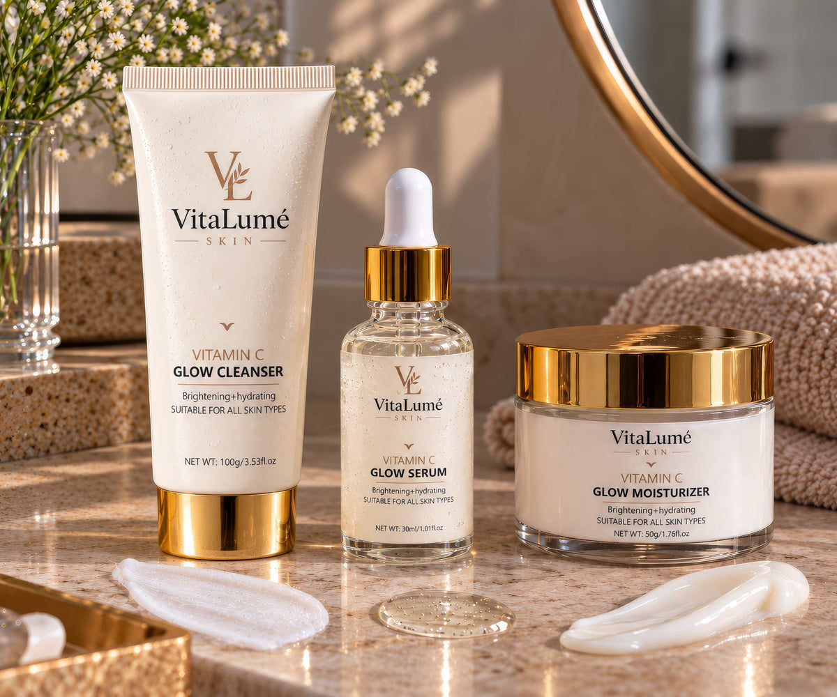 Skincare Products of VitaLumé skincare in cream and clear containers with gold accents, featuring cleanser, serum and moisturizer