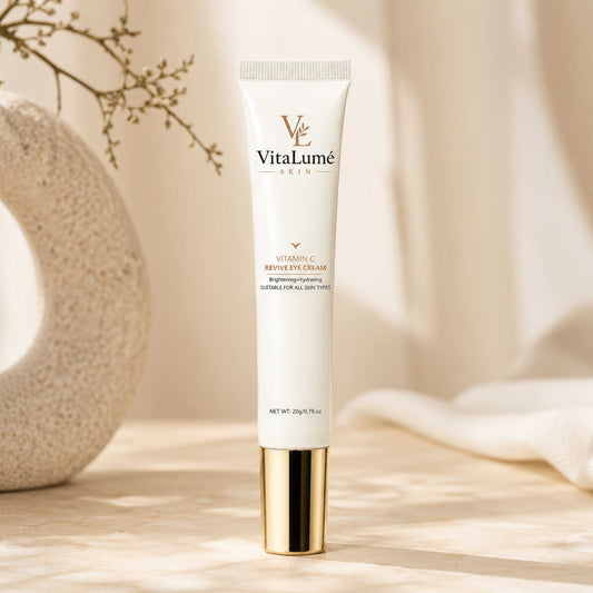 Eye Cream in a slim ivory tube with gold accents, a white ribbed cap, and elegant VitaLumé branding.