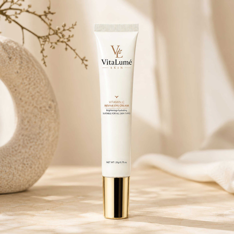 Eye Cream in a slim ivory tube with gold accents, a white ribbed cap, and elegant VitaLumé branding.