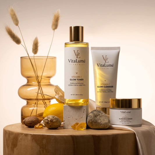 Skincare set featuring a golden toner bottle, cream cleanser tube and moisturizer jar for skin barrier repair